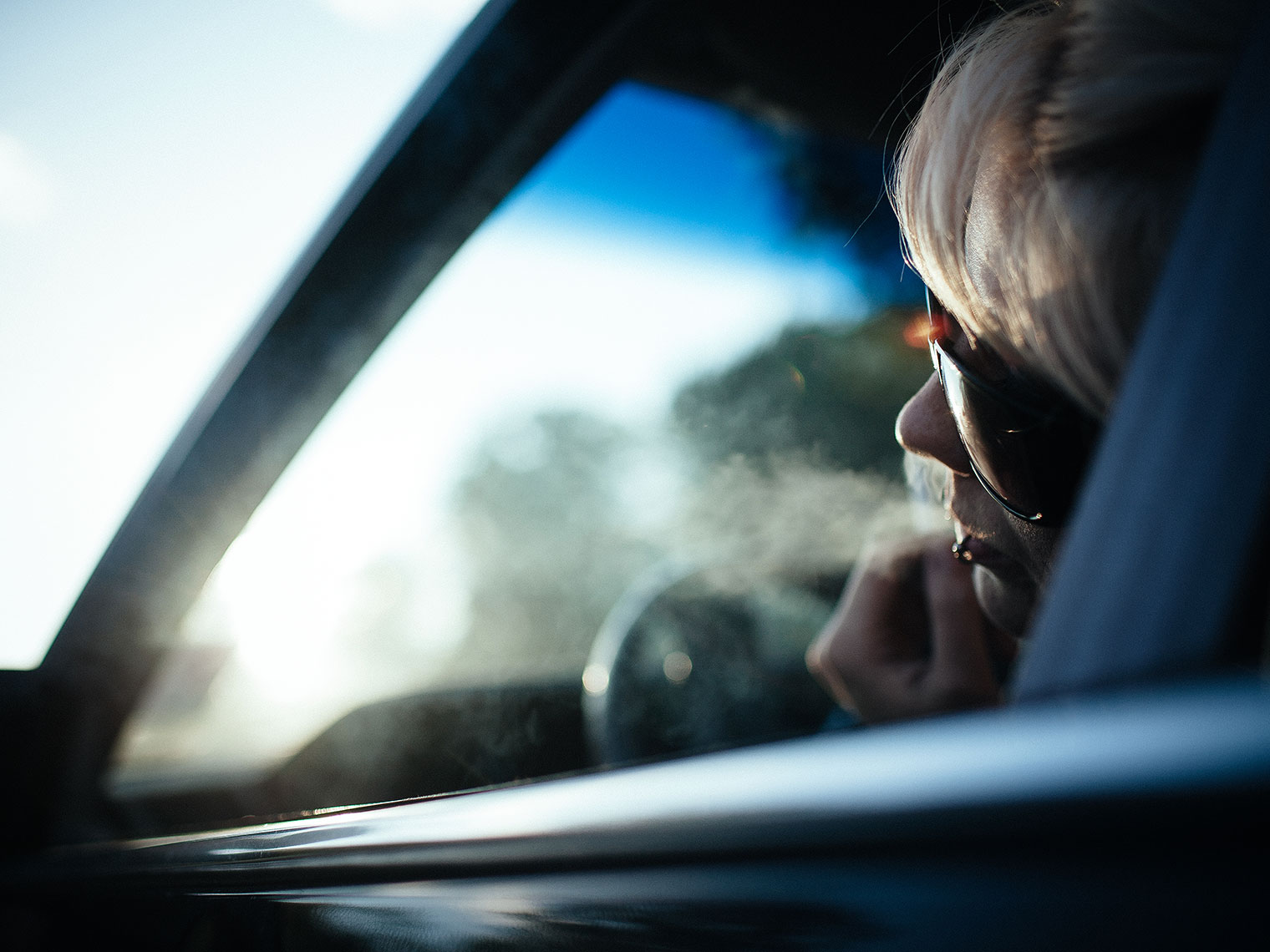 Girl smoking out of her car